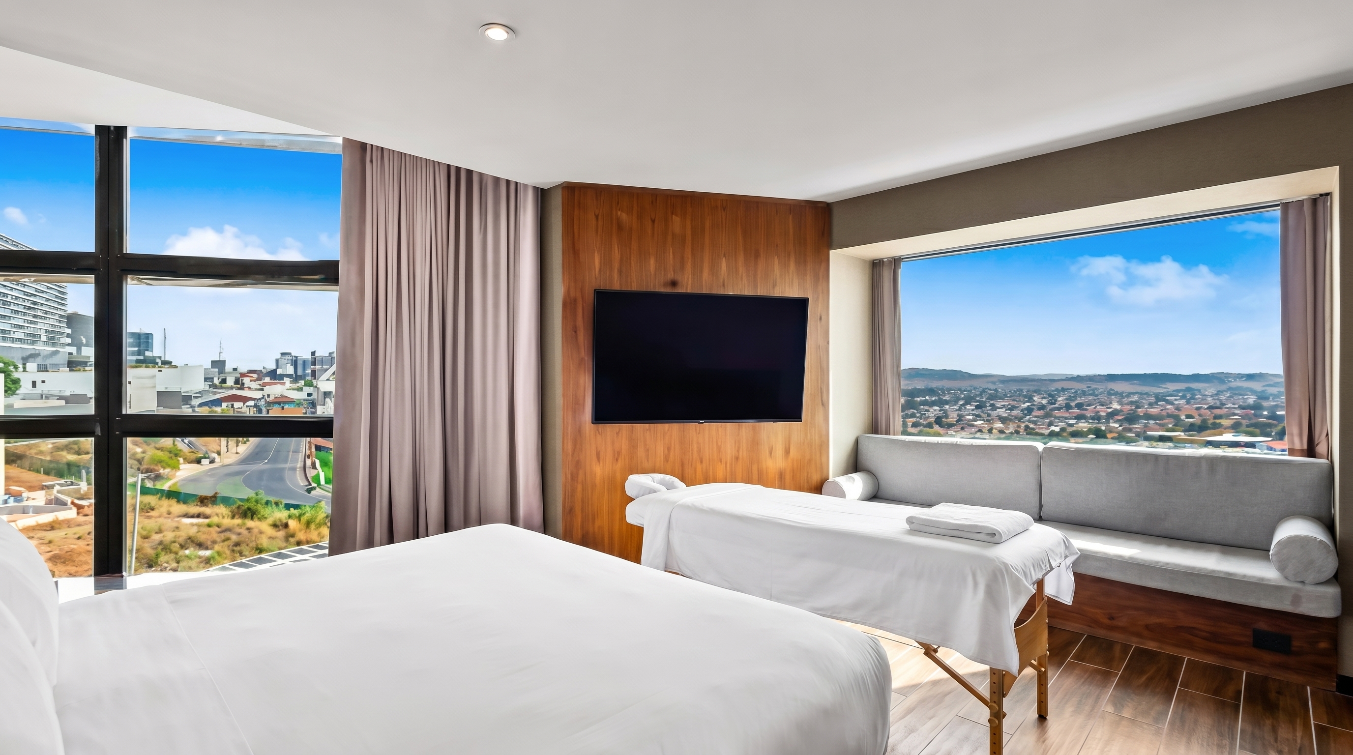 Habitación de hotel con camilla de masaje profesional junto a la ventana